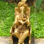GANESH READING BOOK IN CHAIR